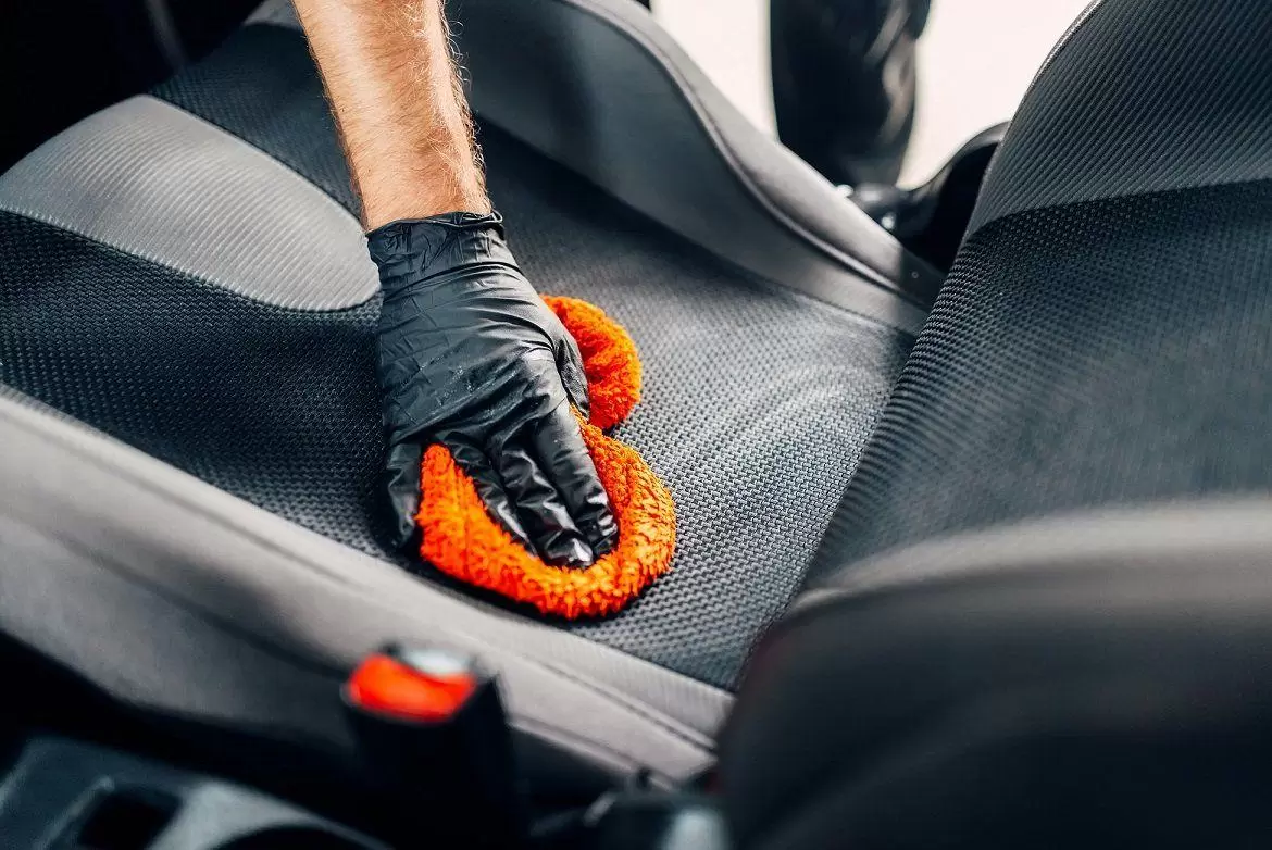 chemical cleaning of car seat with spoonge